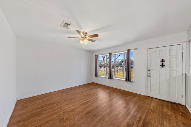 entryway with baseboards, wood finished floors, visible vents, and a ceiling fan