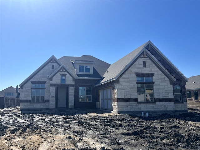 view of front of house with a garage and stone siding