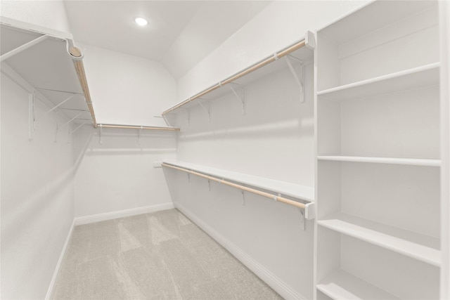 walk in closet with carpet