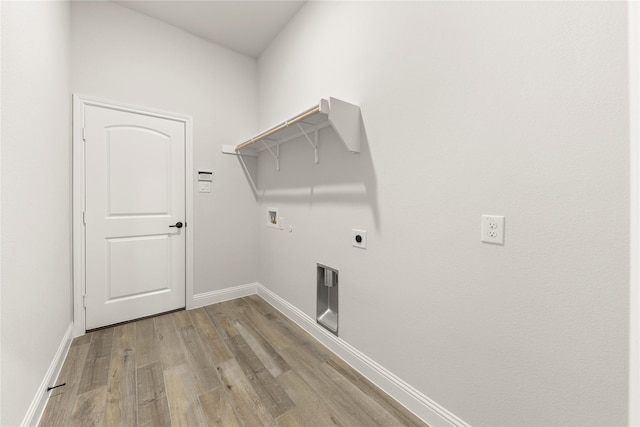 clothes washing area featuring laundry area, washer hookup, light wood-style floors, baseboards, and hookup for an electric dryer