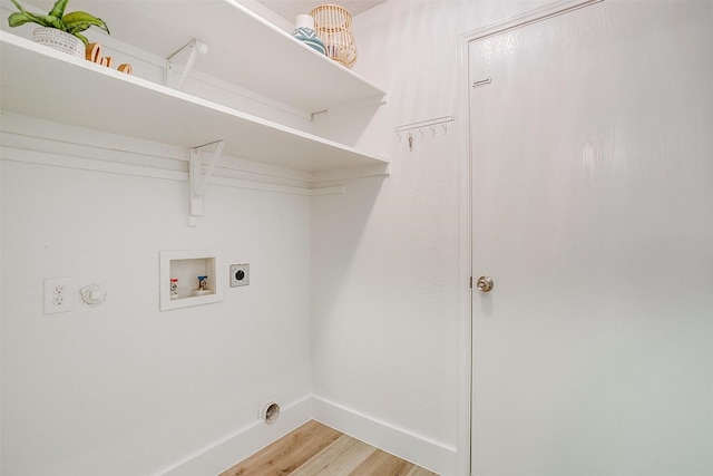 laundry area with hookup for a washing machine, electric dryer hookup, wood finished floors, laundry area, and baseboards