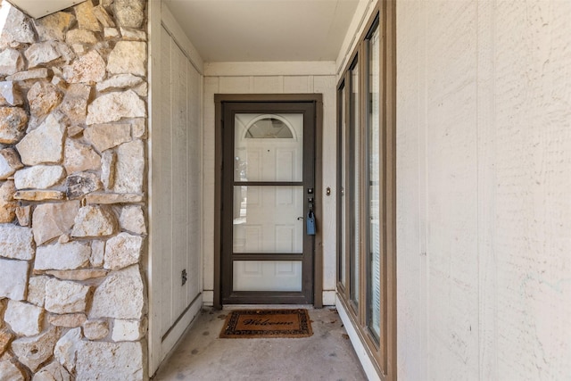 doorway to property featuring stone siding