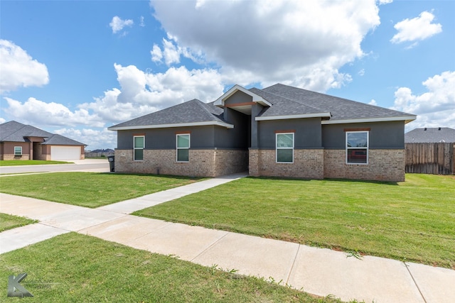 7001 Coldwater Dr, Abilene, TX 79601 - prairie-style home with stucco siding, a shingled roof, and brick siding