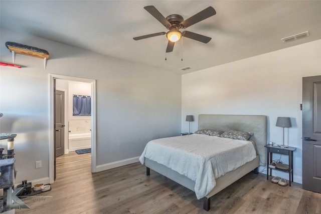 bedroom featuring a ceiling fan, dark wood finished floors, visible vents, and baseboards