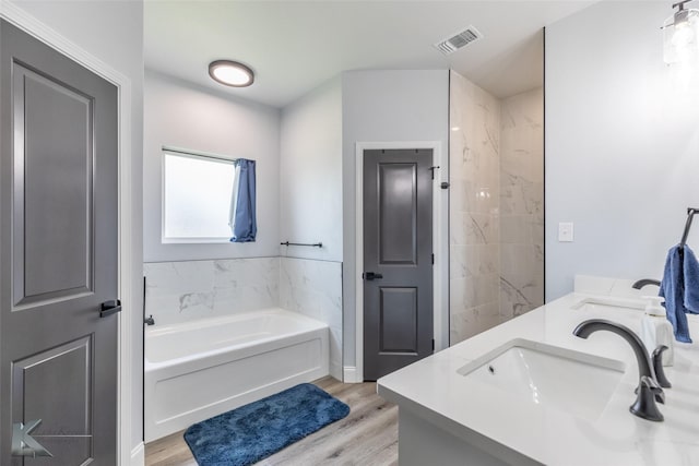 7001 Coldwater Dr, Abilene, TX 79601 - bathroom with a garden tub, wood finished floors, and double vanity