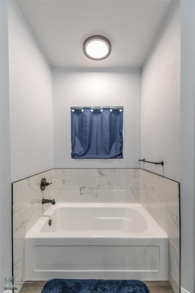 full bathroom with wood finished floors and a garden tub