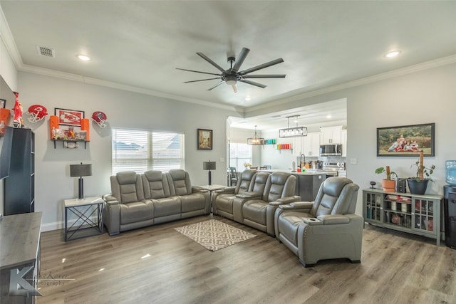 living room with crown molding, recessed lighting, visible vents, ceiling fan, and wood finished floors