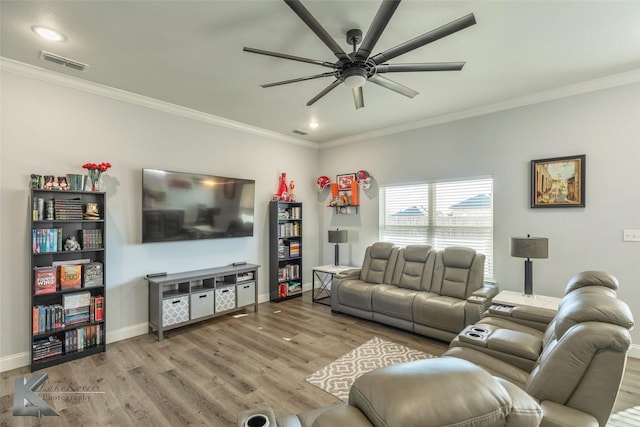 living area featuring wood finished floors, visible vents, and crown molding