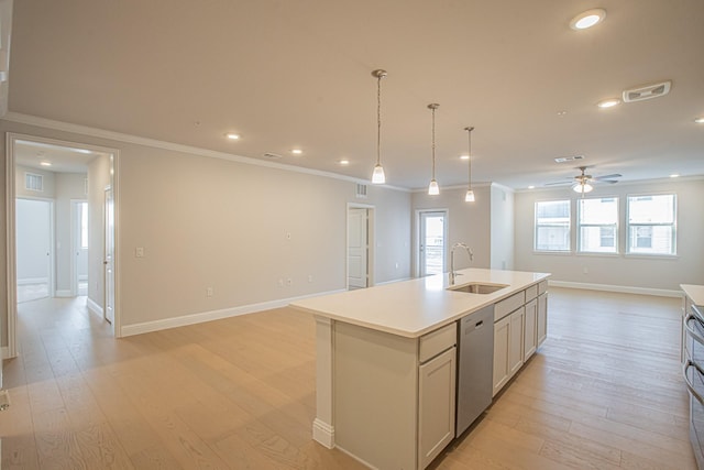 kitchen with a center island with sink, light countertops, stainless steel dishwasher, open floor plan, and a sink