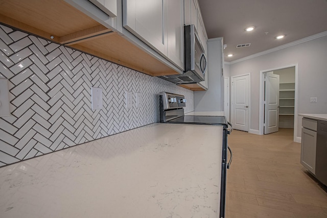 kitchen featuring recessed lighting, light countertops, visible vents, decorative backsplash, and appliances with stainless steel finishes