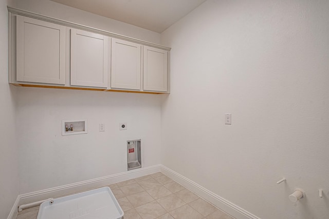 laundry area featuring cabinet space, baseboards, hookup for a gas dryer, hookup for an electric dryer, and washer hookup