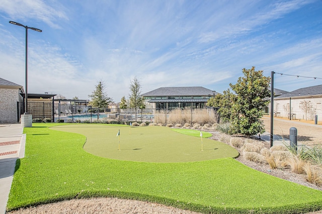 view of community featuring fence and a swimming pool