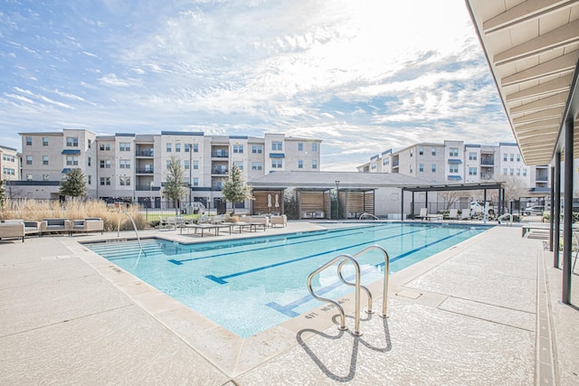 pool featuring fence, a pergola, and a patio