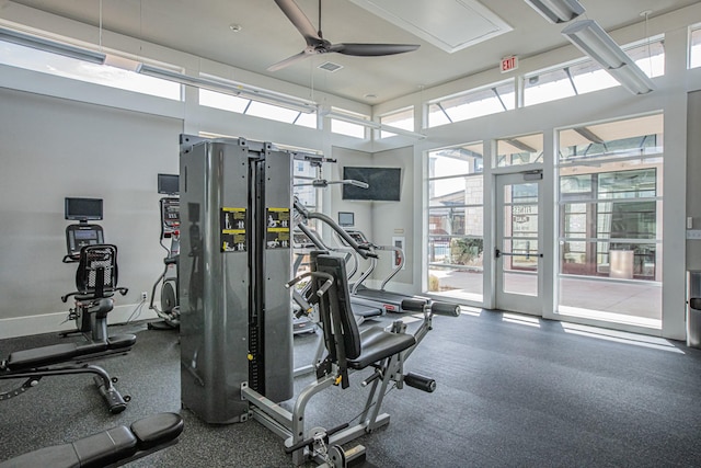 gym featuring ceiling fan and baseboards