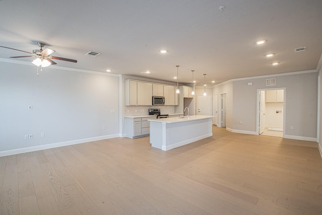 kitchen with a center island with sink, open floor plan, decorative light fixtures, stainless steel appliances, and light countertops