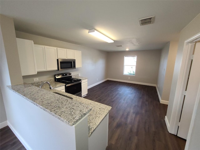 kitchen featuring visible vents, appliances with stainless steel finishes, a peninsula, light stone countertops, and white cabinetry