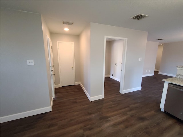 interior space featuring dark wood-style floors, visible vents, and baseboards