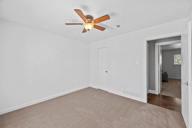 unfurnished bedroom with carpet, visible vents, and baseboards