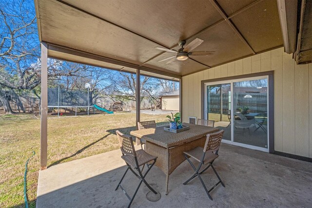 view of patio / terrace featuring ceiling fan, a trampoline, and outdoor dining space