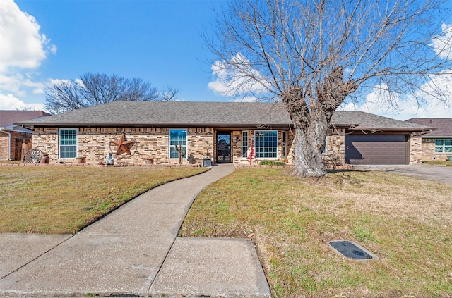 ranch-style home with a garage, a shingled roof, aphalt driveway, a front yard, and brick siding