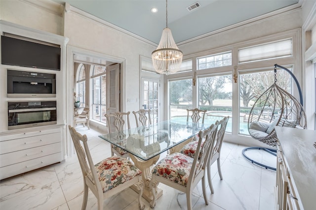 dining room featuring a chandelier, marble finish floor, visible vents, and crown molding