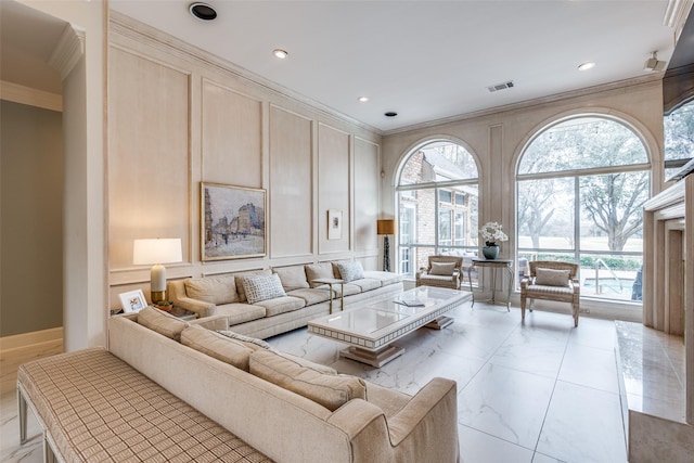 living room with ornamental molding and a decorative wall