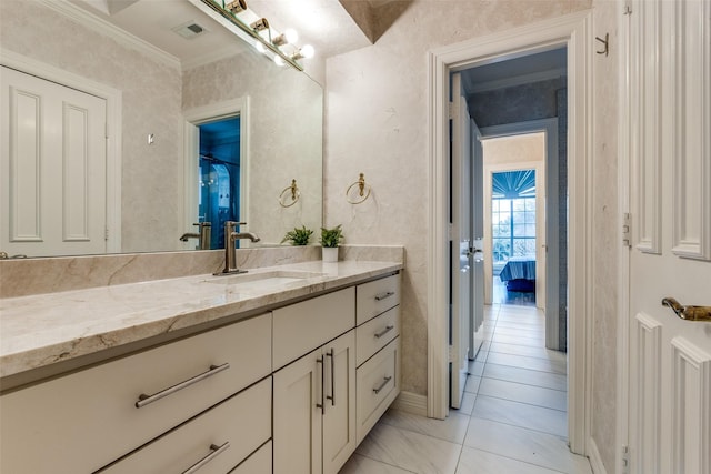 bathroom with ensuite bathroom, visible vents, ornamental molding, and vanity