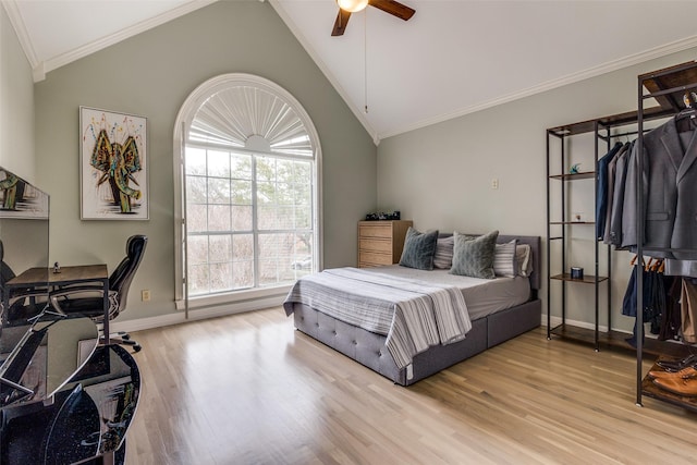 bedroom featuring vaulted ceiling, light wood-type flooring, baseboards, and crown molding