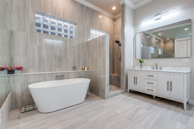 full bath featuring tile walls, a freestanding bath, ornamental molding, vanity, and tiled shower