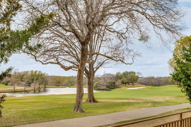 view of community with a lawn and a water view