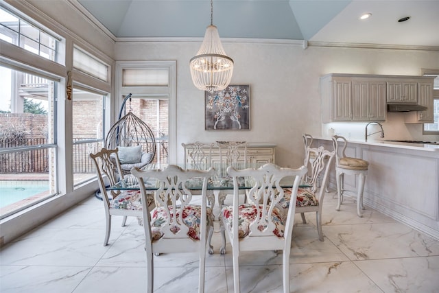 dining area with a chandelier, marble finish floor, and plenty of natural light