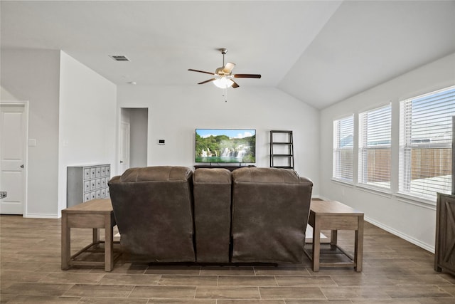 living area featuring wood tiled floor, lofted ceiling, and baseboards