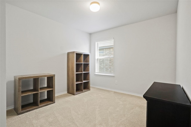 miscellaneous room featuring carpet flooring and baseboards