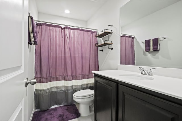 bathroom with toilet, curtained shower, and vanity