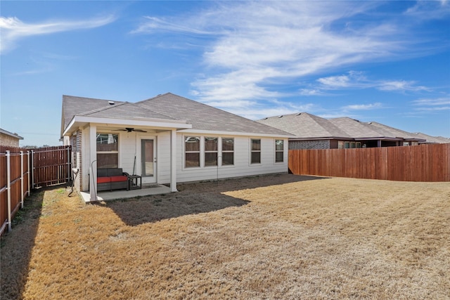 rear view of property with a patio area, ceiling fan, a lawn, and a fenced backyard