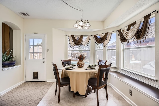 dining room with plenty of natural light, visible vents, a notable chandelier, and baseboards