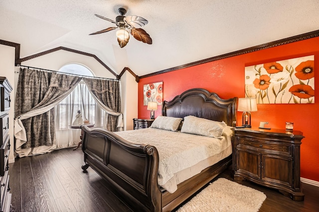 bedroom with dark wood finished floors, lofted ceiling, ornamental molding, ceiling fan, and a textured ceiling