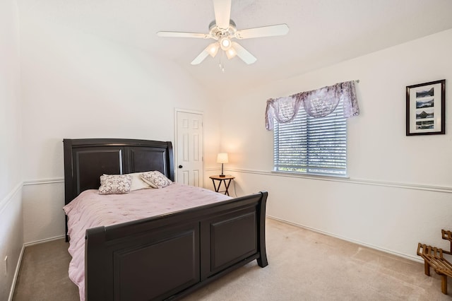 bedroom with lofted ceiling, a ceiling fan, and light colored carpet