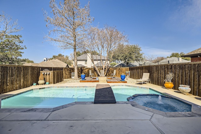 view of pool featuring a fenced backyard and a pool with connected hot tub