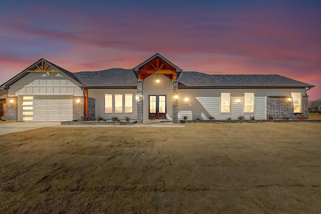 view of front facade with a front yard, driveway, and an attached garage