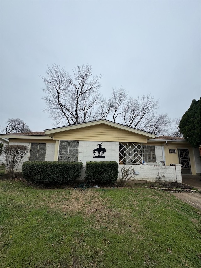 view of side of home with a lawn