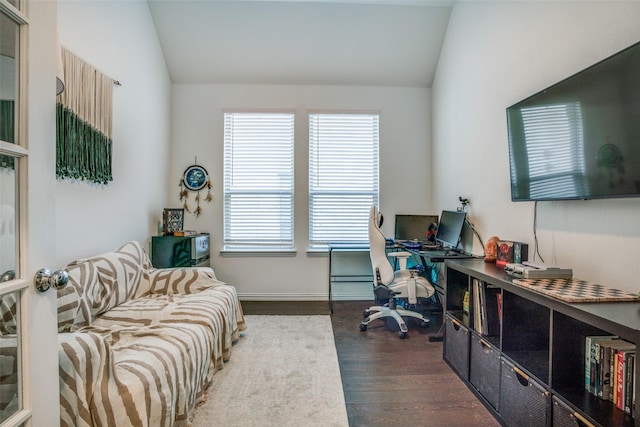 office space with wood finished floors, baseboards, vaulted ceiling, and plenty of natural light