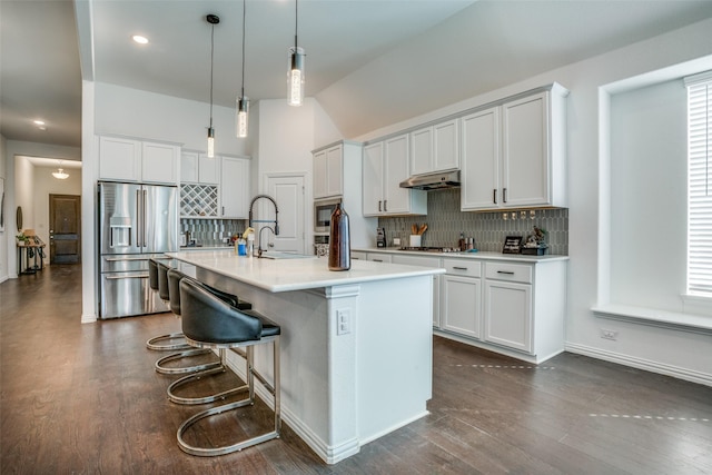 kitchen featuring a center island with sink, white cabinets, appliances with stainless steel finishes, light countertops, and a sink