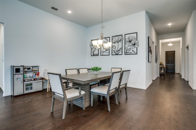 dining room with baseboards, dark wood-style flooring, a notable chandelier, and visible vents