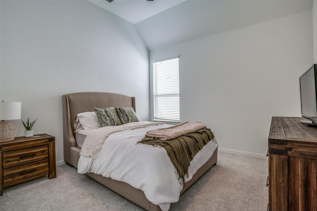 bedroom featuring vaulted ceiling, baseboards, and light colored carpet