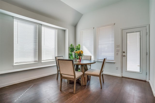 dining space with vaulted ceiling, dark wood-style flooring, and baseboards