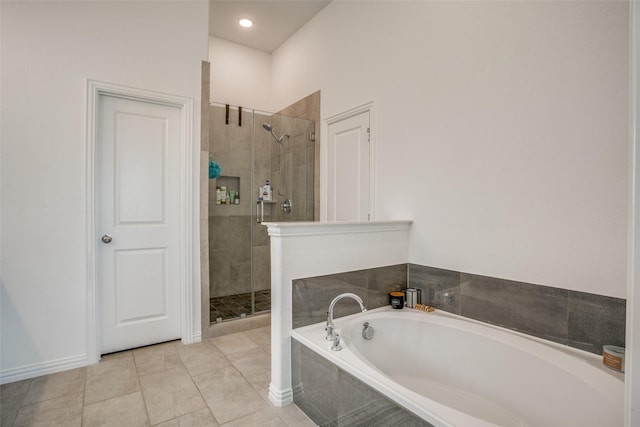 bathroom with a shower stall, a bath, and tile patterned floors