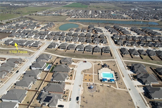 birds eye view of property featuring a residential view and a water view