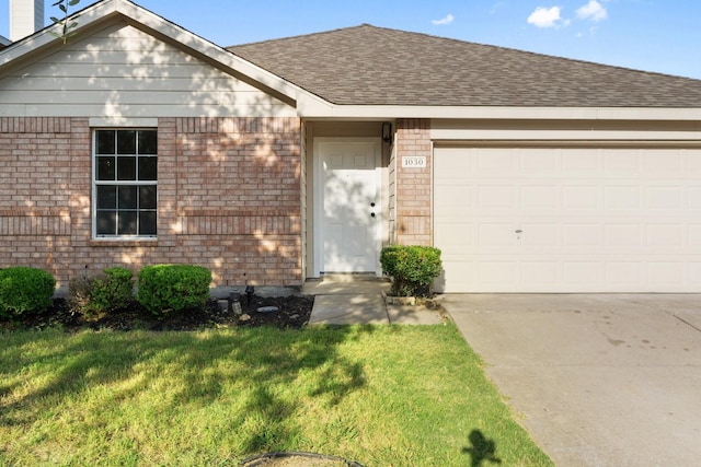 view of front of property with a shingled roof, concrete driveway, and brick siding