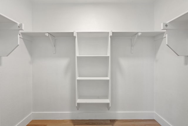 spacious closet with wood finished floors